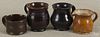 Three Pennsylvania small redware pitchers, 19th c., largest - 3 3/4'' h., together with a redware cup