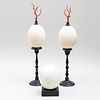 Pair of Ostrich Eggs on Ebonized Mounts and Another Ostrich Egg