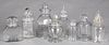 Eight colorless glass candy or apothecary bottles
