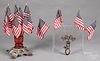 Two wood and metal American flag display stands