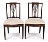Pair of carved mahogany racquetback dining chairs