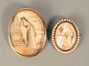Two Memorial Pins each with woman at memorial, one with religious poem surrounded by small pearls. 
2" x 1 1/2" and 1 1/4" x 1".
Pro...
