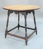 Tavern Table having round maple top on over scalloped apron set on turned splayed legs with box stretcher on round feet, in old black paint with gold 