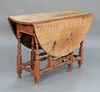 Gateleg Drop Leaf Table with long drawer, maple with tiger maple top, traces of old red paint, New England, circa 1700.
height 27 1/...