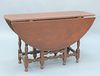 William & Mary Gateleg Dining Room Table in old red paint having oval top, over one long drawer on block turned legs ending in ball ...