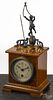Junghans rotary mystery shelf clock with barber pole inlay and a figural putti, 13 1/2'' h.