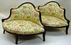 Pair of carved wood upholstered love seats. Ovoid Shape.