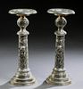 Pair of Large Silverplated Spelter Pricket Candlesticks, 20th c., the candle cup on a relief ball socle, atop a cylindrical support...