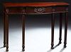 English Hepplewhite Style Carved Mahogany Bowfront Console Table, 20th c., with a central reeded drawer and skirt on tapered square...