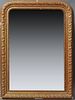 French Louis Philippe Style Gilt and Gesso Overmantle Mirror, 19th c., the arched frame with relief leaf and berry decoration, aroun...