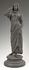 Ebonized Spelter Standing Female Figure, early 20th c., on an integral stepped circular base, H.- 14 1/2 in., Dia.- 5 1/4 in.