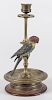 Brass candlestick, early 20th c., with a cold painted bronze cockatiel, 10 3/4'' h.