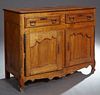 French Provincial Louis XV Style Carved Cherry Sideboard, c. 1850, the rectangular canted corner top over two frieze drawers above d...