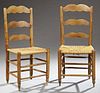 Pair of French Provincial Carved Cherry Rush Seat Side Chairs, 19th c., the three serpentine horizontal splats over a woven rush sea...