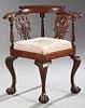 Chippendale Style Carved Mahogany Corner Chair, early 20th c., the curved tablet crest over wide arms above pierced splats above a s...