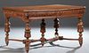 French Henri II Style Carved Oak Dining Table, late 19th c., the stepped canted corner top over a highly carved frieze, on ring and...