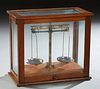 Double Beam Analytical Balance Scale, early 20th c., in a glass and mahogany display case, H.- 16 in., W.- 18 in., D.- 9 1/2 in.