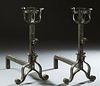 Pair of Large French Medieval Style Wrought Iron Andirons, 19th c., with pierced curved bow tops on square supports with tool hooks,...