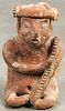 Pre-Columbian seated ceramic figure with a red slip finish, 8 1/4'' h. Provenance: DeHoogh Gallery