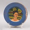 Emilia Castillo. Plato "Frida Kahlo". Firmado y fechado 03. En cerámica azul con aplicaciones de plata baja, pintado a mano.