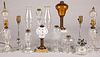 Eleven glass fluid and table lamps.