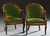 Pair of Louis Philippe Empire Style Carved Beech Bergeres, 19th c., the curved back over swan head arms and a bowed seat on curved saber legs, now uph