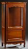 French Louis XV Style Carved Cherry Curio Cabinet, 20th c., the stepped serpentine top over a single door with a glazed upper panel, over a fielded lo
