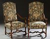Pair of Louis XIII Style Carved Oak Fauteuils a la Reine, early 20th c., the arched canted high back flanked by curved arms, above a cushioned seat, o
