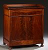 Diminutive Louis Philippe Style Carved Mahogany Sideboard, 19th c., the rounded corner 3/4 galleried top with an inset oil cloth writing surface, over