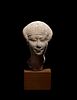 An Egyptian Limestone Head of a Noblewoman
Height 4 inches.