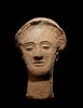 A Greek Terracotta Head
Height 10 inches.