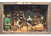 Well made diorama of workshop with man carving and woman painting.