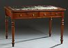 English Carved Mahogany Writing Table, 19th c., the rounded edge and corner stepped top with remnants of an inset cloth writing surface, over two frie