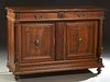 French Provincial Henri II Style Carved Walnut Sideboard, c. 1880, the stepped rounded edge top over two long frieze drawers above two setback relief 