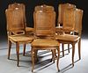 Set of Six French Louis XVI Style Carved Beech Dining Chairs, 20th c. the arched crest rails with shell carving over canted caned backs and stepped bo