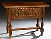French Renaissance Style Carved Walnut Console Table, early 20th c., the rounded corner rectangular top over a deep drawer with carved front panels, o