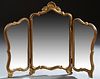 Louis XV Style Carved Gilt Wood Folding Triptych Dresser Mirror, 20th c., with a shell carved crest over an arched center plate, flanked by two like s