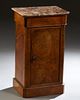 French Louis Philippe Carved Walnut Marble Top Nightstand, 19th c., the canted corner highly figured brown marble over a frieze drawer and a long cupb