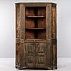Carved Pine Corner Cupboard, possibly Pennsylvania, early 19th century, the convex shelved upper section above two hinged raised panel