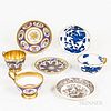 Three Porcelain Cups and Four Saucers, including a Sevres gilt and floral-decorated set and a Coalport blue and white cup and saucer.