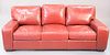 Red leather sofa with matching chair and footstool, ht. 37", wd. 87".