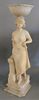 Marble figural sculpture, standing woman having column with a bowl resting on top, repaired, ht. 27 3/4", wd. 7", dp. 7".