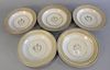 Set of five Chinese Export Armorial porcelain, having gold rims and a central shield with face, minor chips, dia. 9 1/4".