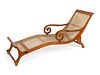 A British Colonial Caned Teak Chaise Longue
Height 33 1/2 x width 27 3/4 x length 80 inches.