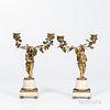 Pair of Gilt-bronze Figural Two-light Candleholders, 19th century, each with a cherub supporting two candle arms adorned with flowers a