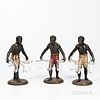 Three Blackamoor Table Figures, 19th century, each painted metal with variously painted breeches, and supporting three glass cups, ht.