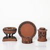 Four Wedgwood Rosso Antico Items, England, 19th century, each with applied black basalt relief, a circular box and cover with zodiac sy