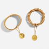 Two gold bracelets with coin charms