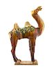 A Sancai Glazed Pottery Figure of a Camel TANG DYNASTY Height 22 3/4 inches.