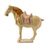 A Straw Glazed Pottery Figure of a Caparisoned Horse TANG DYNASTY Height 12 7/8 inches.